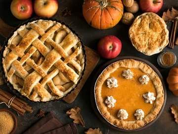 apple pie and pumpkin pie on table