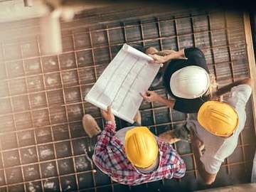 construction workers consulting blueprint