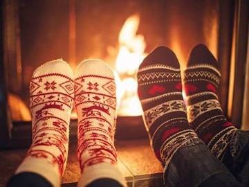 couple-with-feet-by-fire