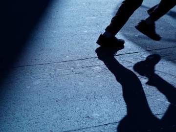 feet of a person running in the dark