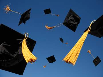 graduation caps in the air