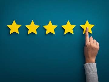 hand pointing to five gold stars
