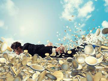 man swimming in money