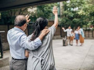 man-and-woman-waving-at-family