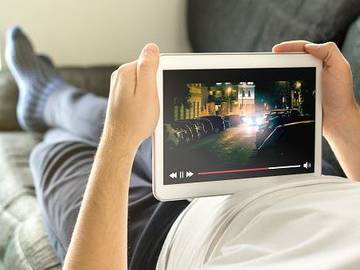 man-lying-with-tablet