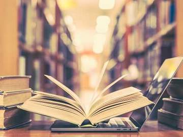 open book on top of open laptop