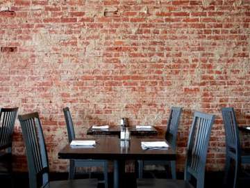 restaurant table setting with brick wall backdrop