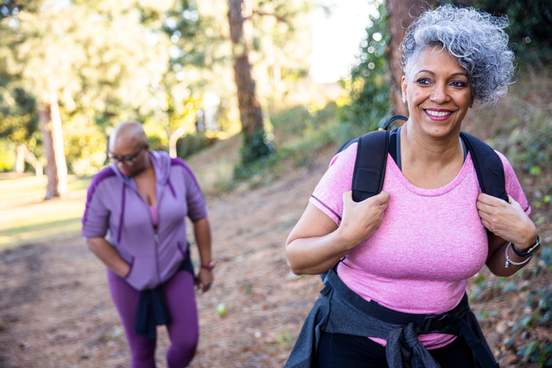 a senior black woman hiking in nature