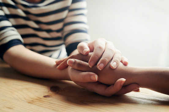 a person holding hand of another person