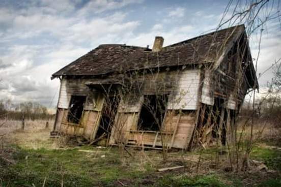 abandoned house leaning to one side
