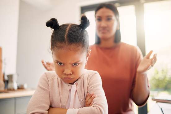 angry little girl unhappy and upset after fight or being scolded by mother