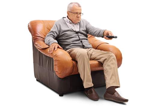 angry senior sitting on an armchair and switching channels isolated on white background