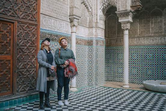 asian chinese female tourist admiring fez mosque bou inania madressa