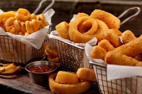 baskets of onion rings and cheese sticks