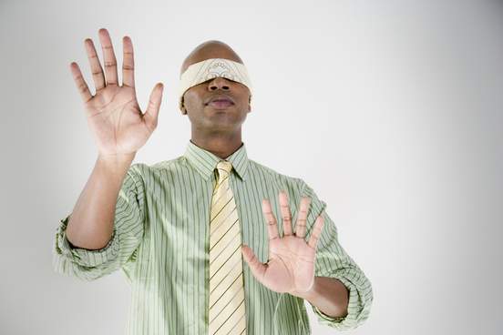 blindfolded man searching with hands