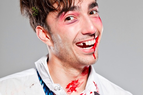 bloodied man happily unaware of his injuries