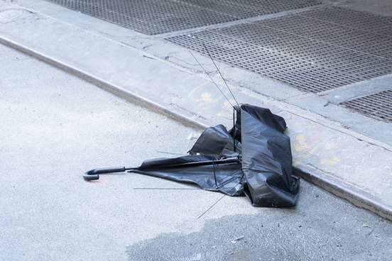 broken umbrella in gutter