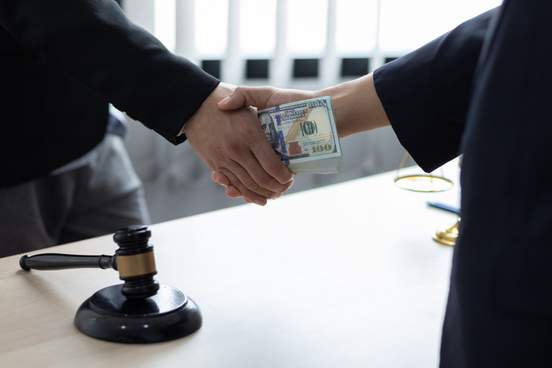 business people shaking hands and bribe to an attorney to help a lawyer win a court case 