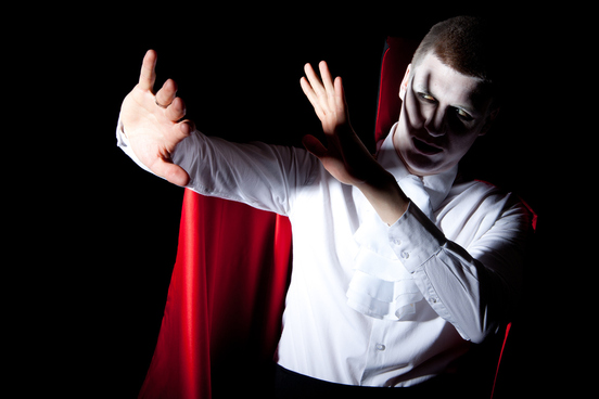 cheesy vampire shielding himself from the light