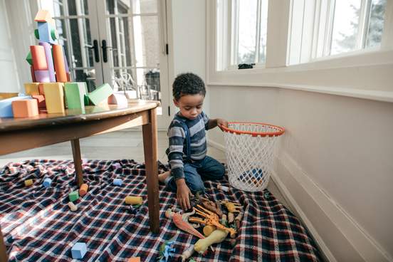 child cleaning up his room