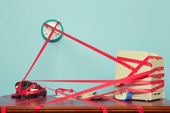 desk-covered-in-red-tape