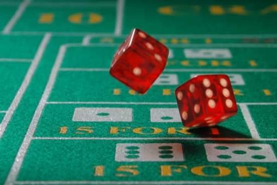 dice being thrown on craps table