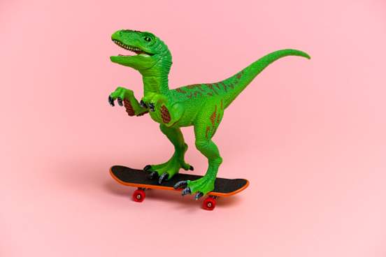 dinosaur toy riding skateboard