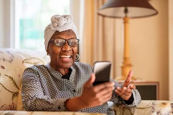 elderly woman video chatting on phone