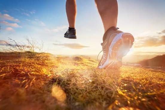 feet of a runner on a trail