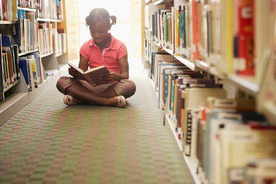 girl reading at the library