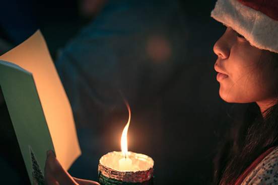 girl singing and holding candle