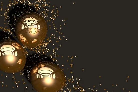 gold balloons and glitter on dark background