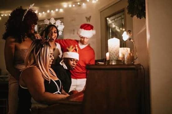 group singing carols at piano