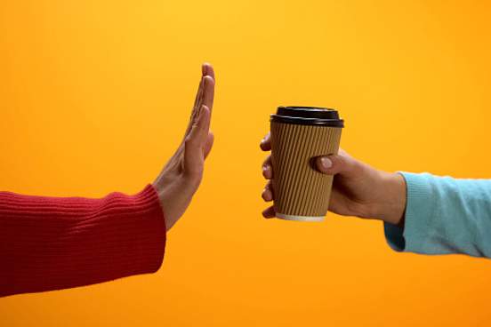 hand refusing cup of coffee