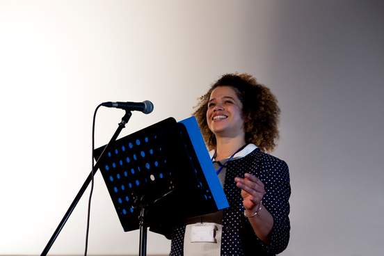 happy woman speaking to a crowd