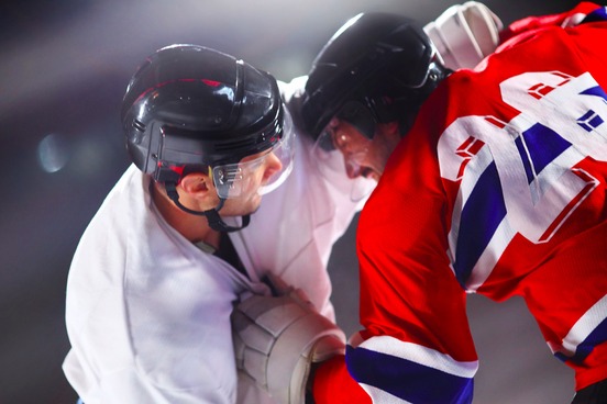 hockey players engaged in fighting