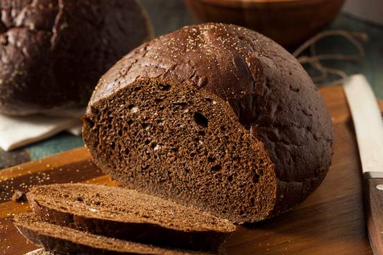 homemade organic pumpernickel rye bread cut into slices