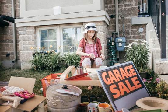 kid helping with garage sale