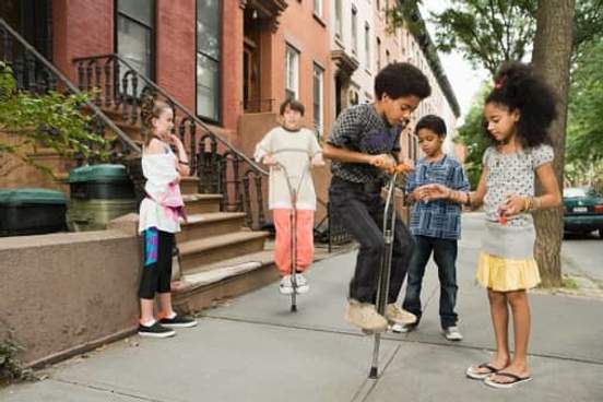 kids playing on pogo sticks