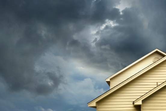 looming clouds over house roof