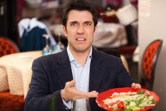 man complaining about food in restaurant