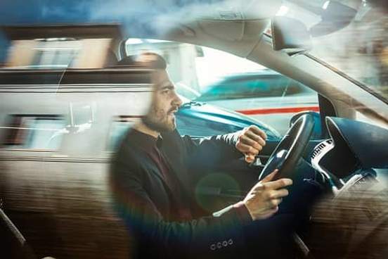 man driving in hurry