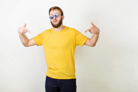 man in blank yellow t-shirt pointing at himself