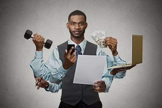 man sprouting several arms to accomplish a number of tasks