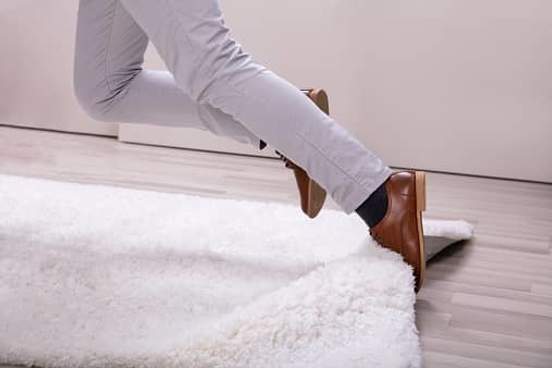 man tripping over carpet