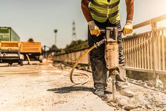 man using jackhammer on street