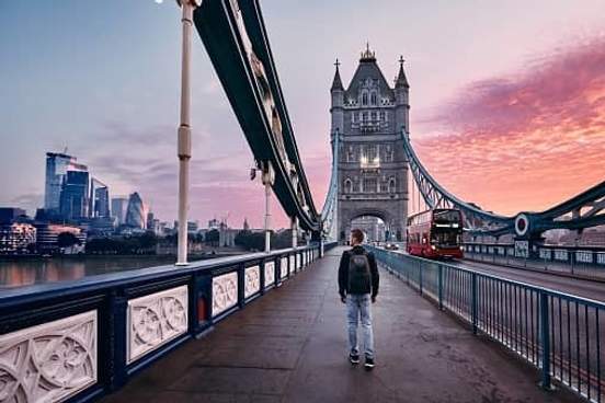 man walking on bridge in london