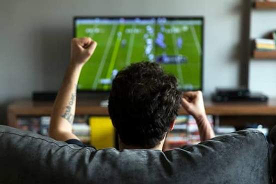 man watching football on tv
