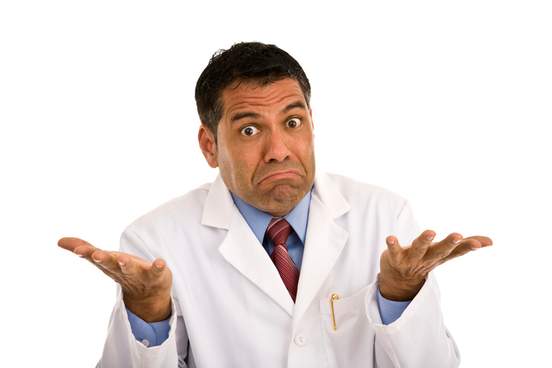 man wearing a lab coat and shrugging