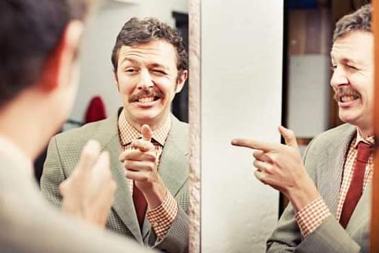 man winking at himself in mirror